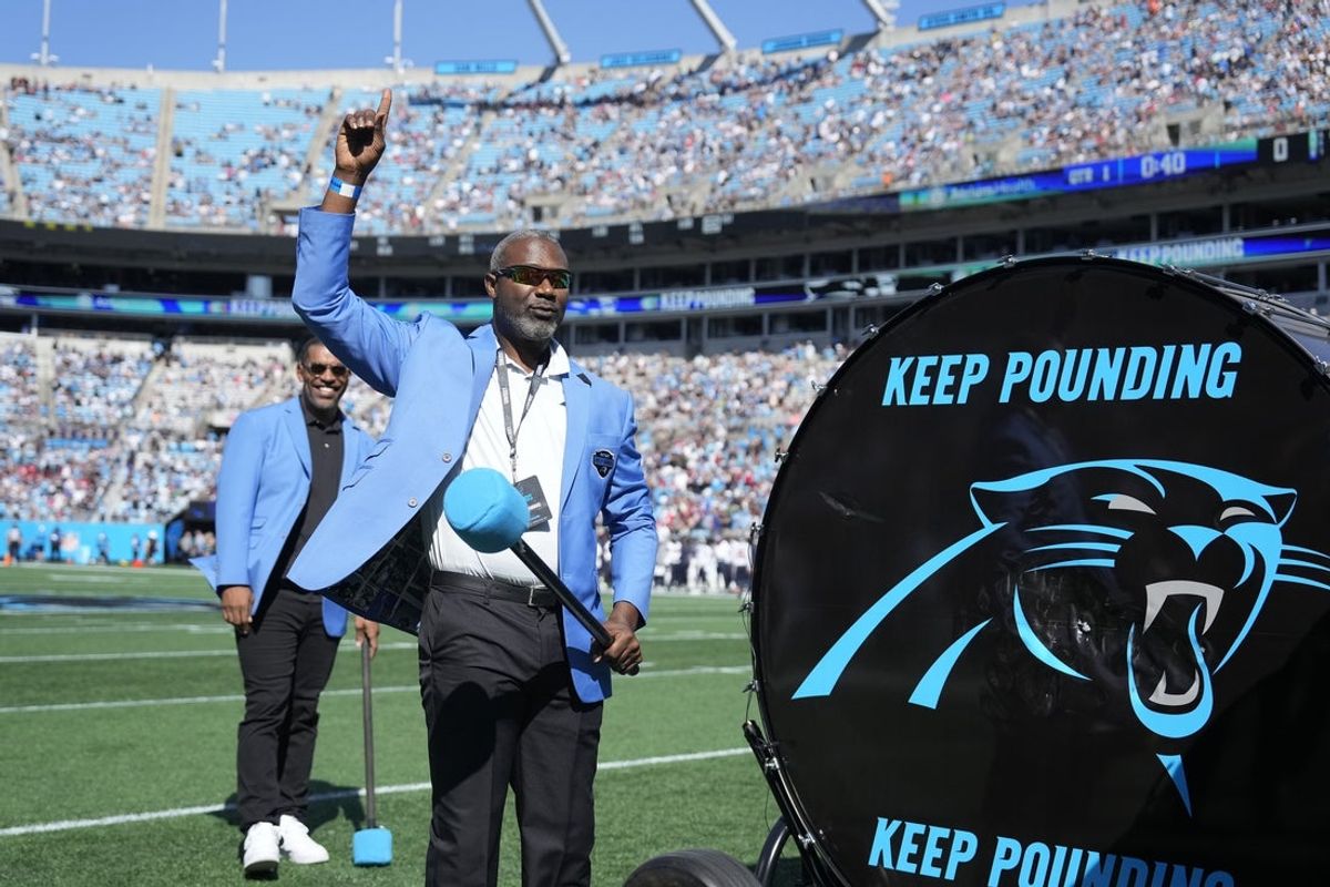 Oct 29, 2023; Charlotte, North Carolina, USA; Former Carolina Panthers greats Muhsin Muhammad salutes the crowd the crowd before the game at Bank of America Stadium. Mandatory Credit: Bob Donnan-Imagn Images