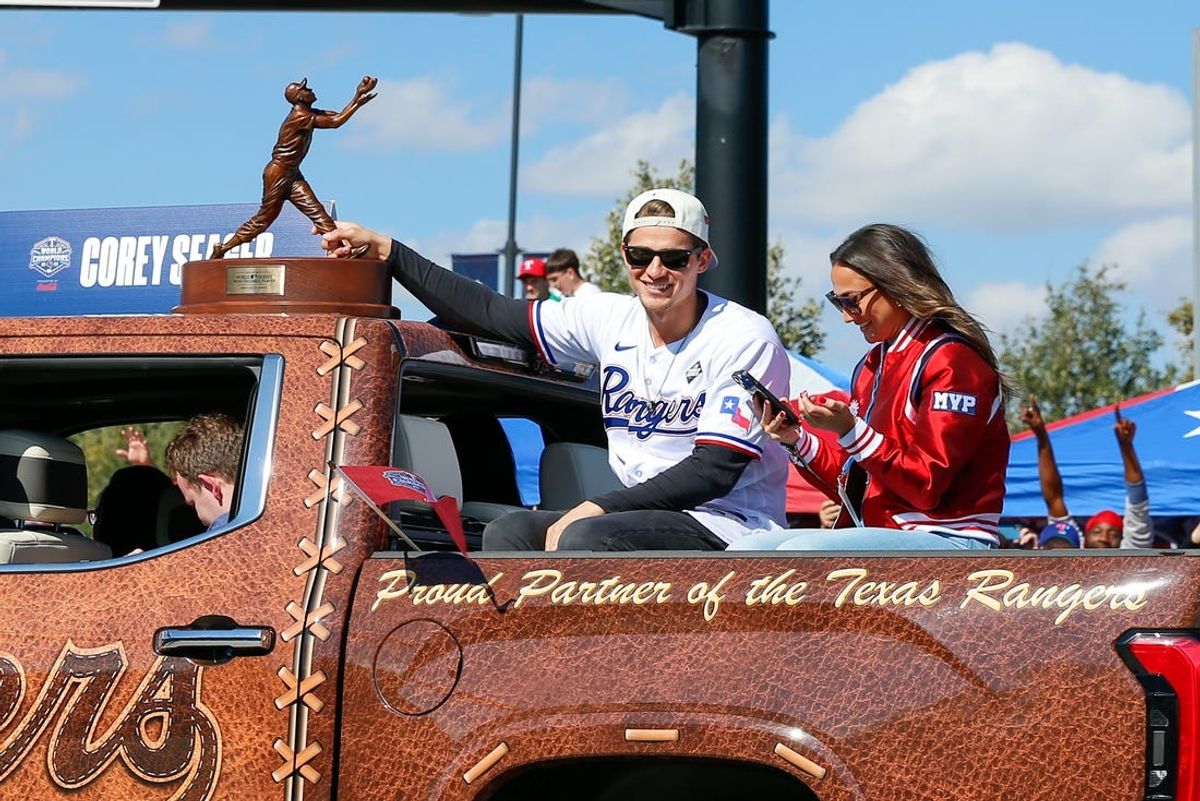 Nov 3, 2023; Arlington, TX, USA; Texas Rangers shortstop Corey Seager (5) holds onto the MVP trophy during the World Series championship parade at Globe Life Field.  Mandatory Credit: Andrew Dieb-USA TODAY Sports