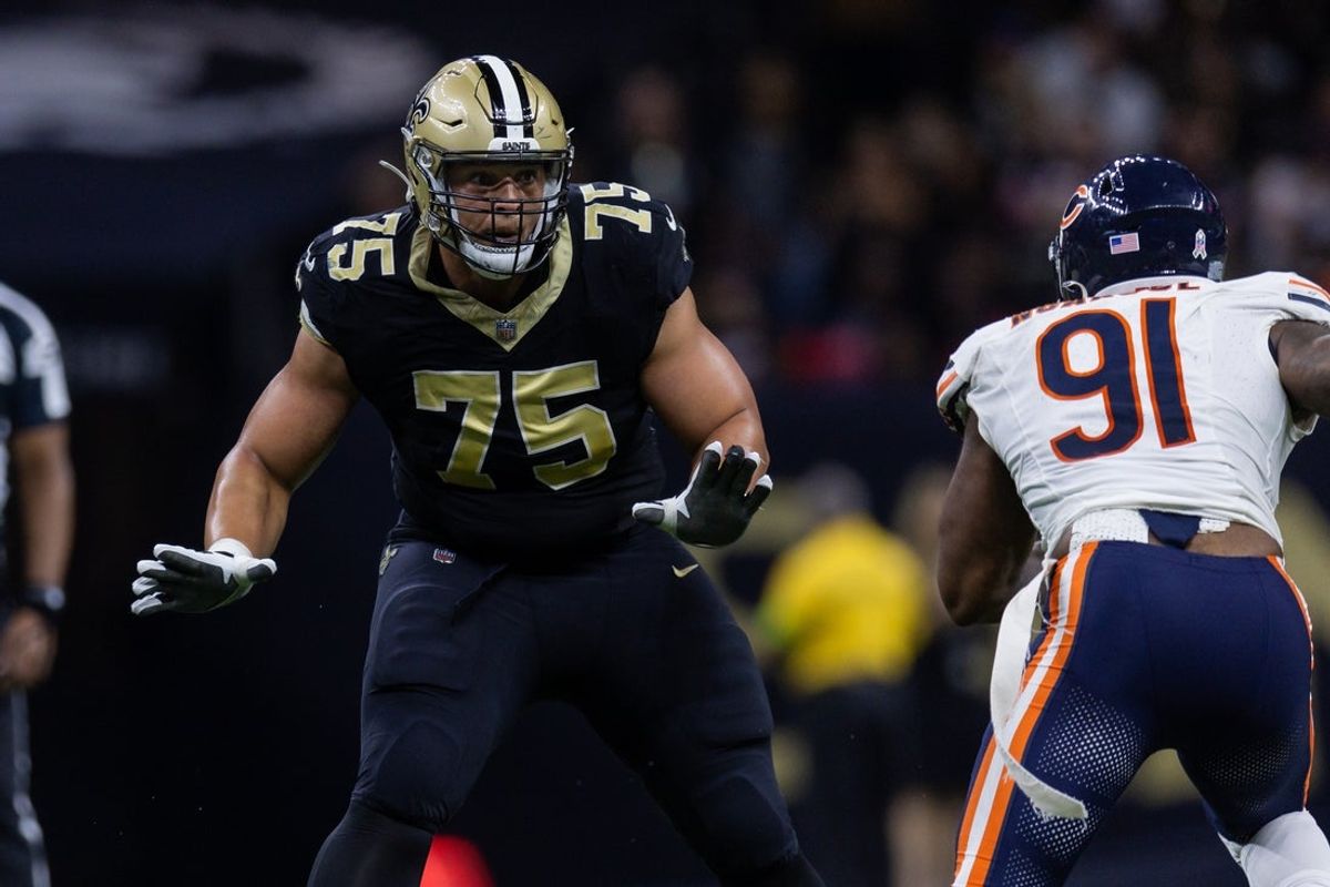 Nov 5, 2023; New Orleans, Louisiana, USA;  New Orleans Saints guard Andrus Peat (75) blocks Chicago Bears defensive end Yannick Ngakoue (91) during the second half at the Caesars Superdome. Mandatory Credit: Stephen Lew-Imagn Images