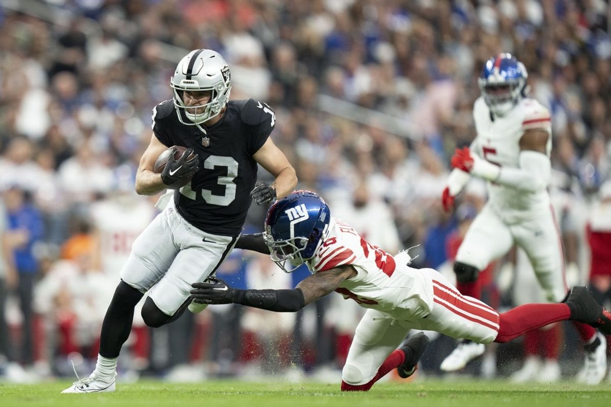 November 5, 2023; Paradise, Nevada, USA; Las Vegas Raiders wide receiver Hunter Renfrow (13) is tackled by New York Giants cornerback Cor'Dale Flott (28) during the second quarter at Allegiant Stadium. Mandatory Credit: Kyle Terada-Imagn Images
