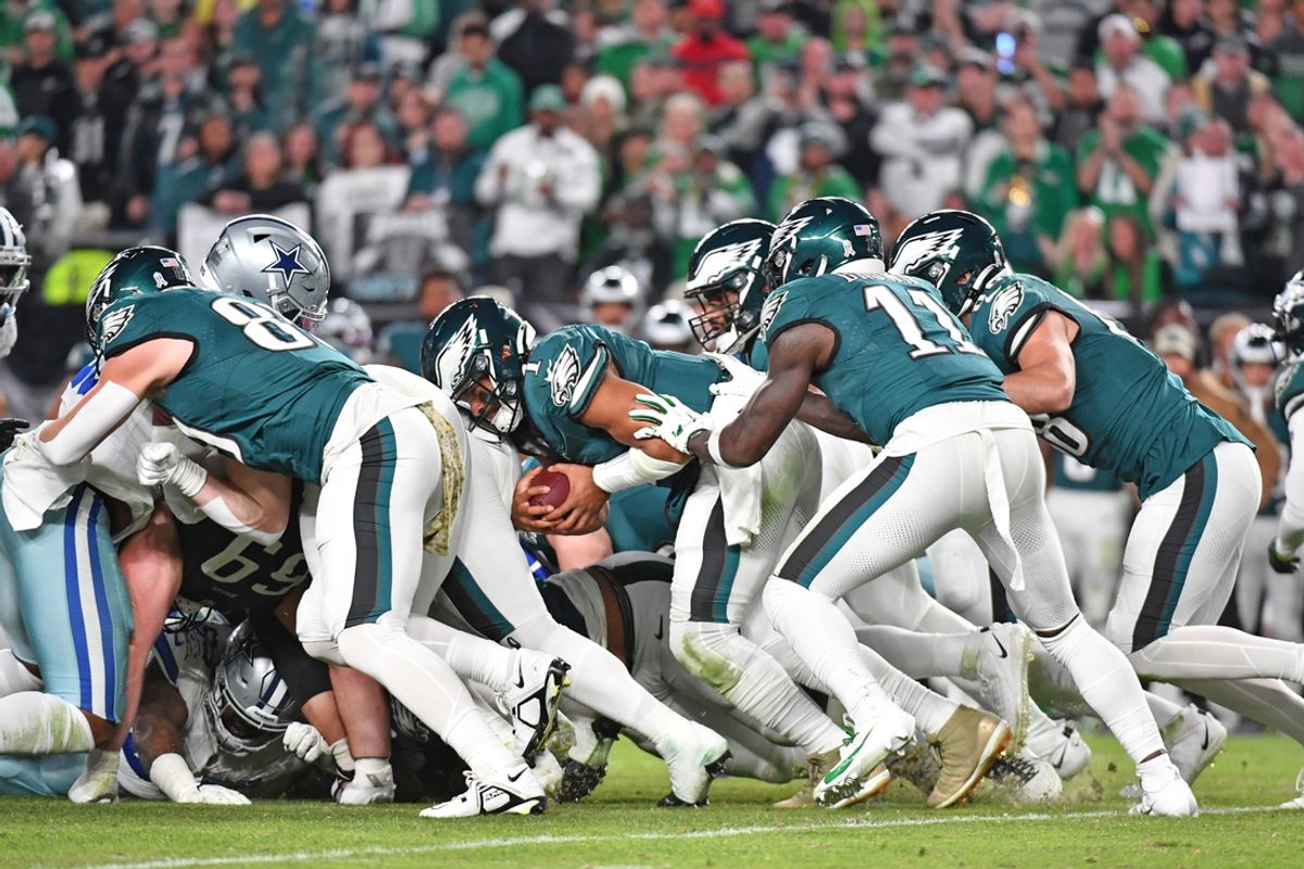 Nov 5, 2023; Philadelphia, Pennsylvania, USA; Philadelphia Eagles quarterback Jalen Hurts (1) picks up yardage a first down with a push from wide receiver A.J. Brown (11) and tight end Dallas Goedert (88) against the Dallas Cowboys at Lincoln Financial Field. Mandatory Credit: Eric Hartline-Imagn Images