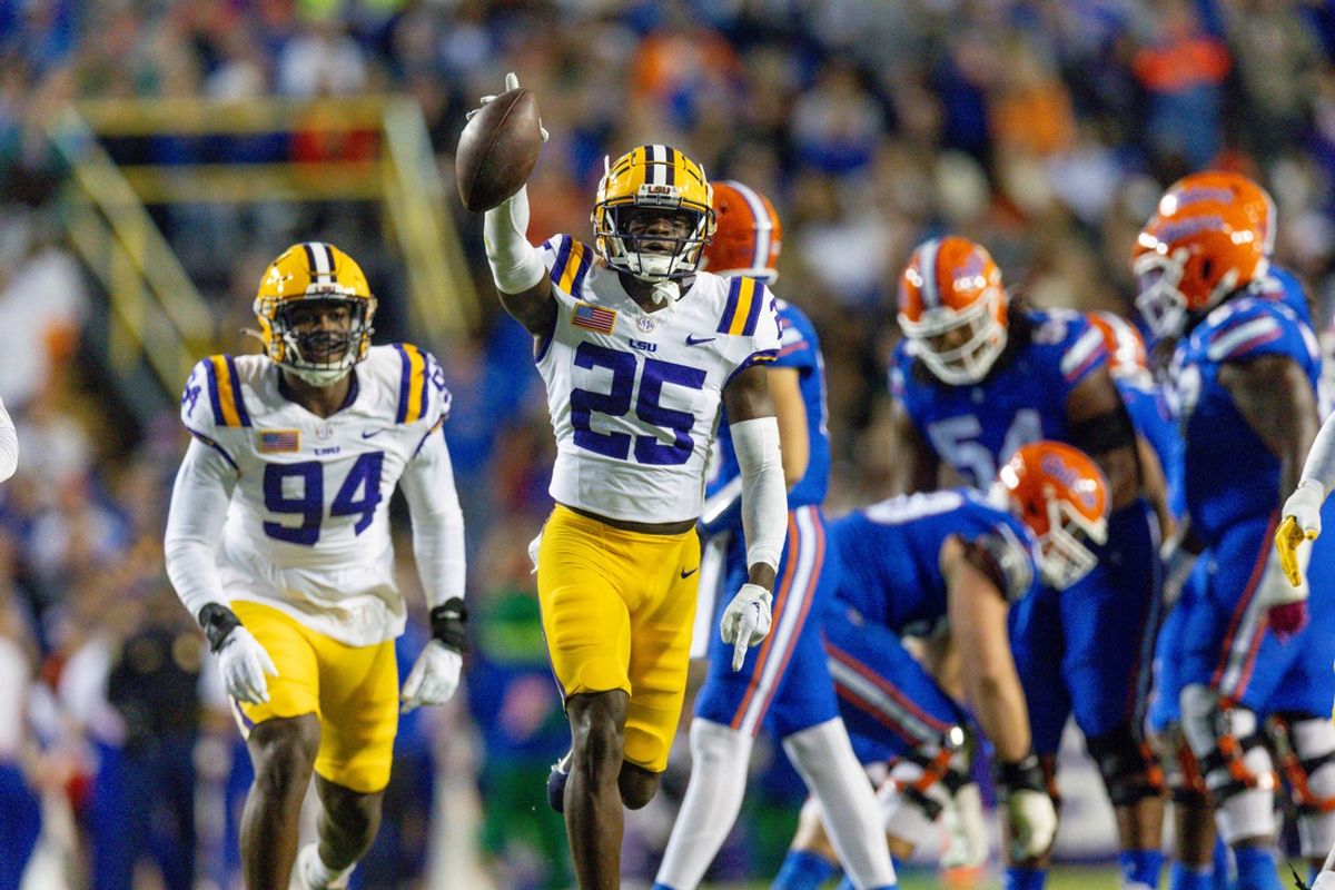 Nov 11, 2023; Baton Rouge, Louisiana, USA; LSU Tigers safety Javien Toviano (25) recovers a fumble against the Florida Gators during the first half at Tiger Stadium. Mandatory Credit: Stephen Lew-USA TODAY Sports