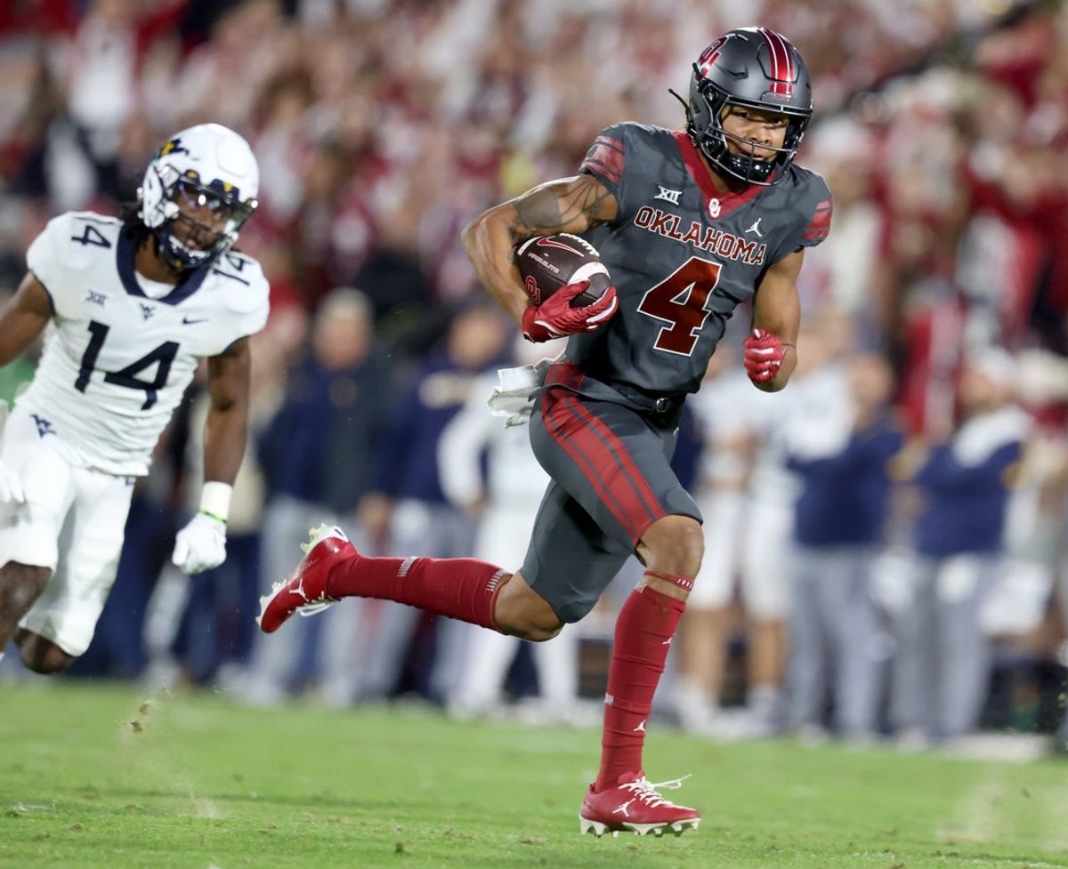 Oklahoma's Nic Anderson (4) runs after a reception as West Virginia's Malachi Ruffin (14) chases him in the first half of a college football game between the University of Oklahoma Sooners and the West Virginia Mountaineers at Gaylord Family-Oklahoma Memorial Stadium in Norman, Okla., Saturday, Nov., 11, 2023.