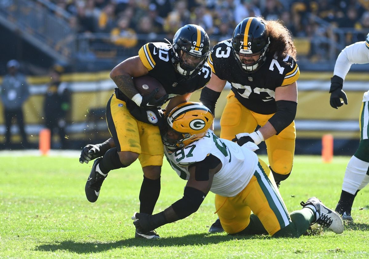 Nov 12, 2023; Pittsburgh, Pennsylvania, USA;  Pittsburgh Steelers running back Jaylen Warren (30) and Green Bay Packers defensive lineman Kenny Clark (97) as offensive lineman Isaac Seumalo (73) follows the play during the first quarter at Acrisure Stadium. Mandatory Credit: Philip G. Pavely-USA TODAY Sports