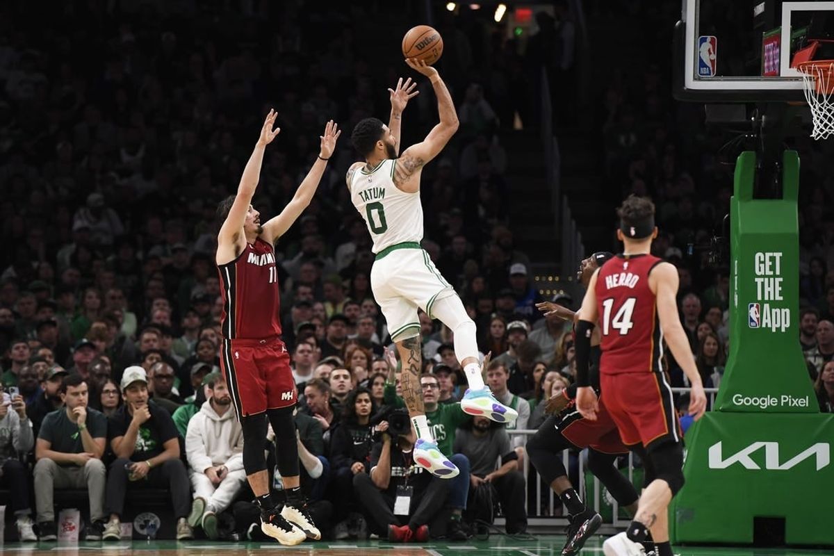 Apr 21, 2024; Boston, Massachusetts, USA; Boston Celtics forward Jayson Tatum (0) shoots the ball while Miami Heat guard Jaime Jaquez Jr. (11) defends during the first half in game one of the first round for the 2024 NBA playoffs at TD Garden.