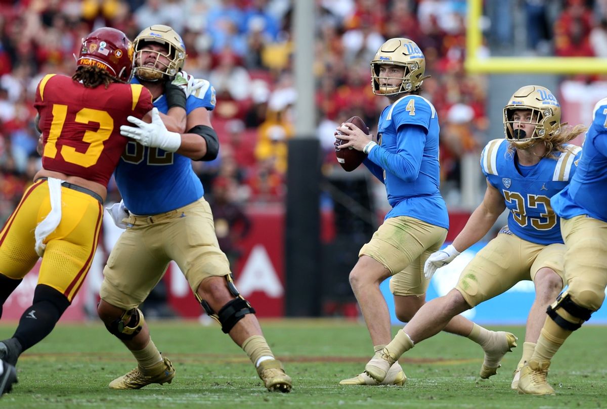 Nov 18, 2023; Los Angeles, California, USA; UCLA Bruins quarterback Ethan Garbers (4) drops to throw during the first quarter against the USC Trojans at United Airlines Field at Los Angeles Memorial Coliseum. Mandatory Credit: Jason Parkhurst-Imagn Images