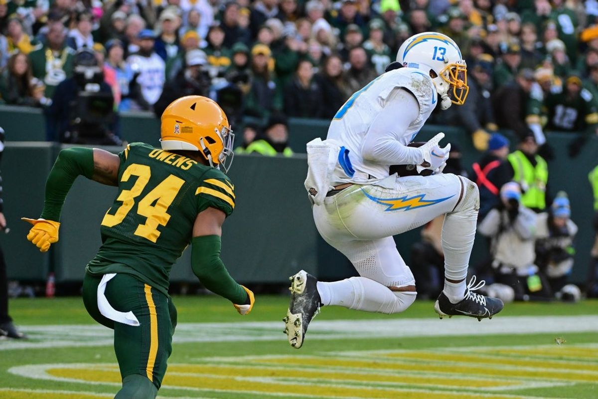 Nov 19, 2023; Green Bay, Wisconsin, USA; Los Angeles Chargers wide receiver Keenan Allen (13) catches a pass in the end zone for a touchdown against Green Bay Packers defensive back Jonathan Owens (34) in the fourth quarter at Lambeau Field. Mandatory Credit: Benny Sieu-Imagn Images
