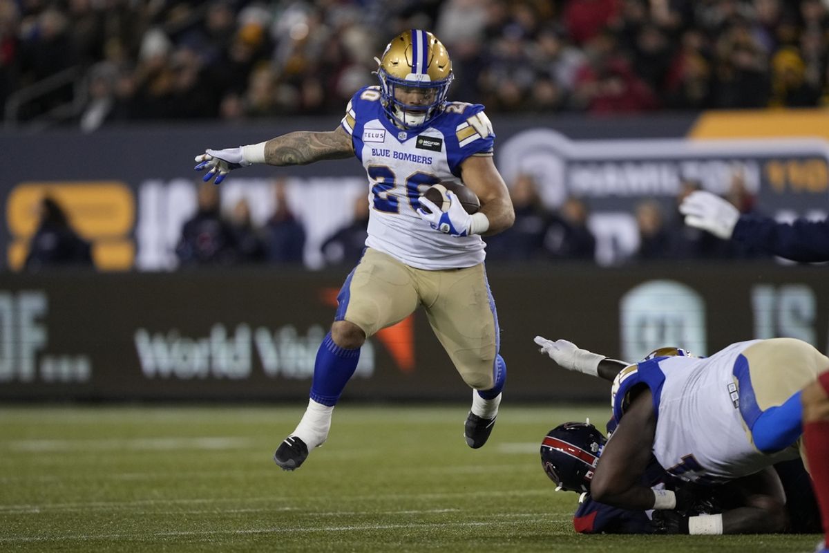 Nov 19, 2023; Hamilton, Ontario, CAN;  Winnipeg Blue Bombers running back Brady Oliveira (20) runs against the Montreal Alouettes during the first quarter of the 110th Grey Cup game at Tim Hortons Field. Mandatory Credit: John E. Sokolowski-Imagn Images