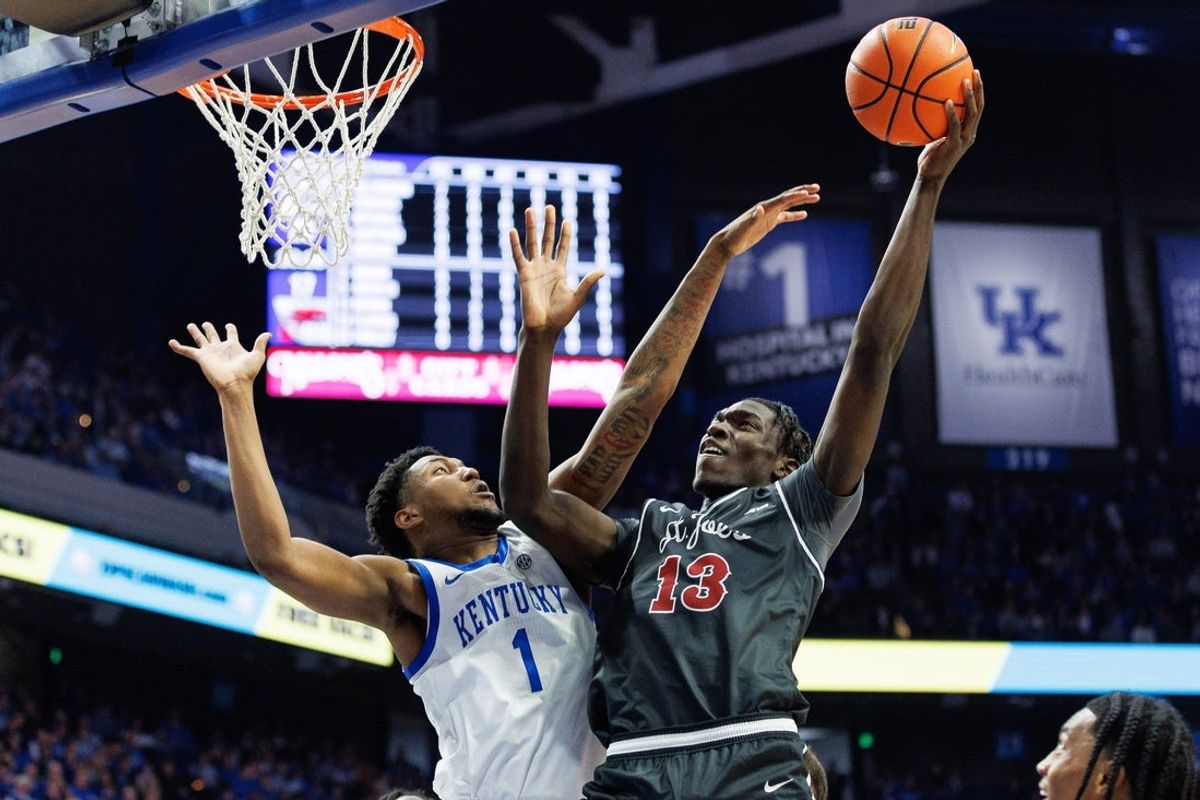 Nov 20, 2023; Lexington, Kentucky, USA; Saint Joseph's Hawks forward Rasheer Fleming (13) goes to the basket against Kentucky Wildcats guard Justin Edwards (1) during the first half at Rupp Arena at Central Bank Center. Mandatory Credit: Jordan Prather-Imagn Images