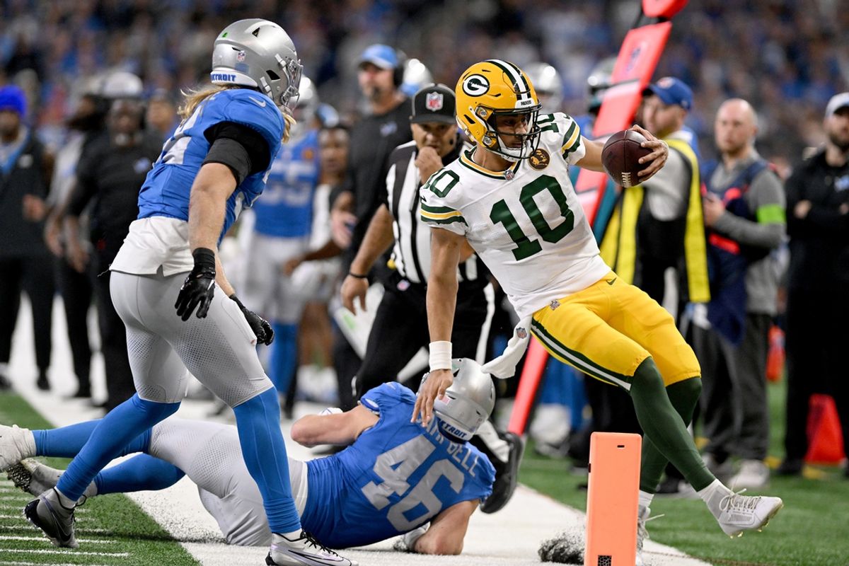 Green Bay Packers quarterback Jordan Love (10) gets forced out of bounds by Detroit Lions linebackers Jack Campbell (46) and Alex Anzalone (34) in the third quarter at Ford Field. Mandatory Credit: Lon Horwedel-USA TODAY Sports