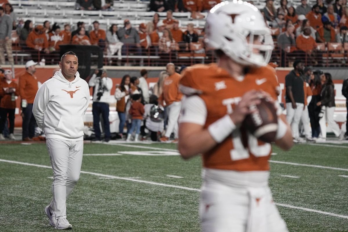 Nov 24, 2023; Austin, Texas, USA; Texas Longhorns head coach Steve Sarkisian observes quarterback Arch Manning (16) warming up before a game against the Texas Tech Red Raiders at Darrell K Royal-Texas Memorial Stadium. Mandatory Credit: Scott Wachter-Imagn Images