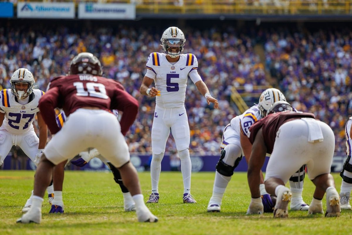 Nov 25, 2023; Baton Rouge, Louisiana, USA;  LSU Tigers quarterback Jayden Daniels (5) calls a play against the Texas A&M Aggies during the first half at Tiger Stadium. Mandatory Credit: Stephen Lew-Imagn Images