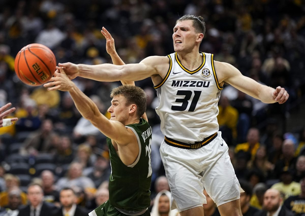 Nov 25, 2023; Columbia, Missouri, USA; Loyola (Md) Greyhounds guard Chris Kuzemka (20) and Missouri Tigers guard Caleb Grill (31) fight for a rebound during the second half at Mizzou Arena. Mandatory Credit: Jay Biggerstaff-Imagn Images