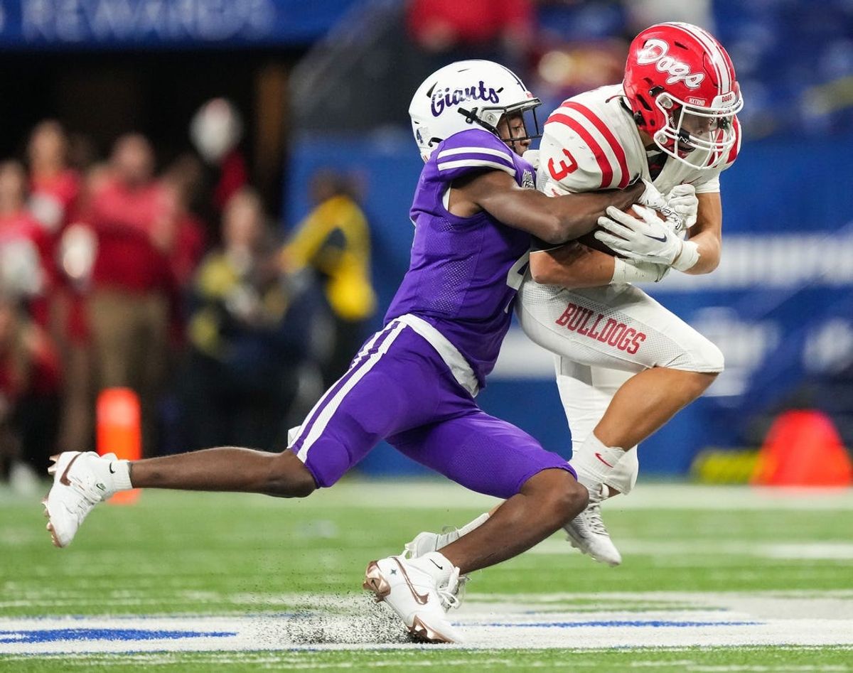 Ben Davis Giants Mark Zackery (4) tackles Crown Point Bulldogs Larry Ellison (3) on Saturday, Nov. 25, 2023, during the IHSAA Class 6A football state championship game at Lucas Oil Stadium in Indianapolis. The Ben Davis Giants lead at the half against the Crown Point Bulldogs, 10-3.