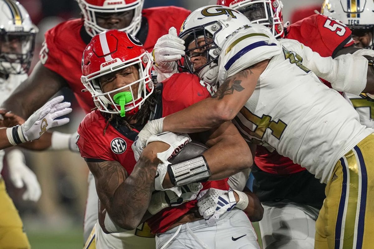 Nov 25, 2023; Atlanta, Georgia, USA; Georgia Bulldogs running back Kendall Milton (2) runs against Georgia Tech Yellow Jackets linebacker Kyle Efford (44) during the second half at Hyundai Field. Mandatory Credit: Dale Zanine-USA TODAY Sports