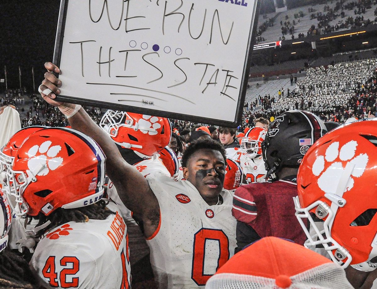Nov 25, 2023; Columbia, South Carolina, USA; Clemson Tigers linebacker Barrett Carter (0) holds a sign \"We Run This State\" near South Carolina Gamecocks linebacker Grayson Howard (5) after defeating South Carolina at Williams-Brice Stadium.  Clemson won 16-7. Mandatory Credit: Ken Ruinard-Imagn Images