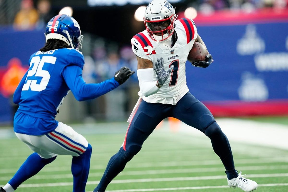 New England Patriots wide receiver DeVante Parker (1) tries to avoid New York Giants cornerback Deonte Banks (25) at MetLife Stadium, Sunday, November 26, 2023.