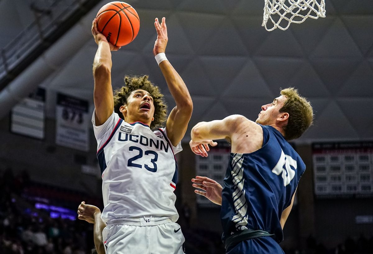 Nov 27, 2023; Storrs, Connecticut, USA; UConn Huskies forward Jayden Ross (23) shoots the ball against New Hampshire Wildcats forward Davide Poser (15) in the second half at Harry A. Gampel Pavilion. Mandatory Credit: David Butler II-Imagn Images