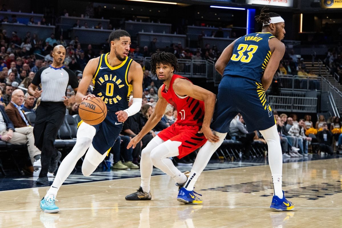 Indiana Pacers guard Tyrese Haliburton (0) dribbles the ball while Portland Trail Blazers guard Shaedon Sharpe (17) defends in the second half at Gainbridge Fieldhouse. Mandatory Credit: Trevor Ruszkowski-Imagn Images