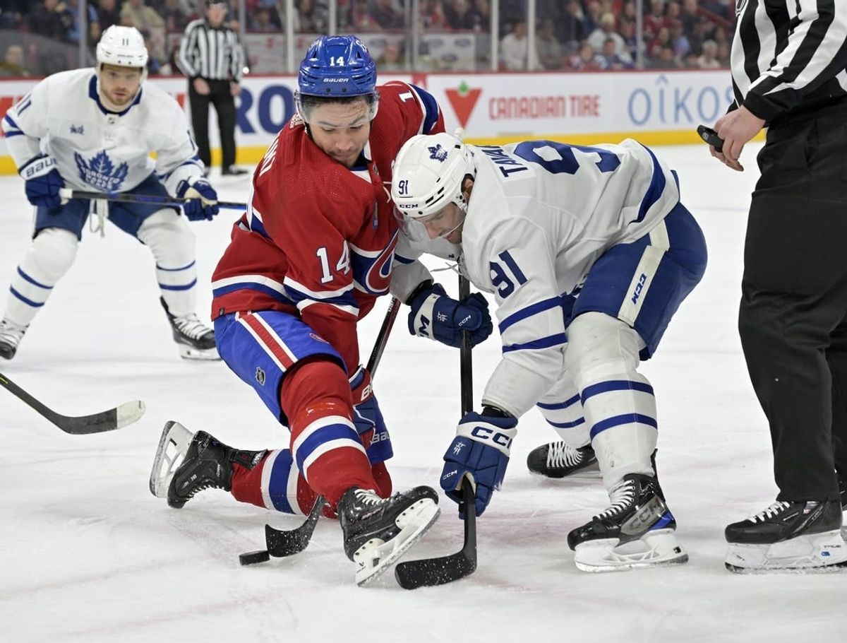 Mar 9, 2024; Montreal, Quebec, CAN: Montreal Canadiens forward Nick Suzuki (14) wins a faceoff against Toronto Maple Leafs forward John Tavares (91) during the first period at the Bell Centre.