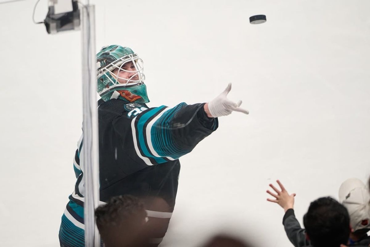 Mar 9, 2024; San Jose, California, USA; San Jose Sharks goaltender Magnus Chrona (30) tosses a puck to a fan after defeating the Ottawa Senators after the game at SAP Center at San Jose.