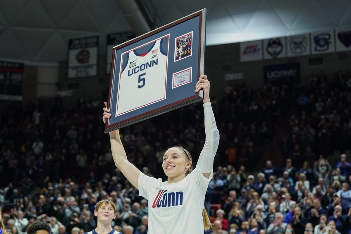 Feb 16, 2024; Storrs, Connecticut, USA; UConn Huskies guard Paige Bueckers (5) holds up her jersey during senior night after defeating the Georgetown Hoyas at Harry A. Gampel Pavilion.