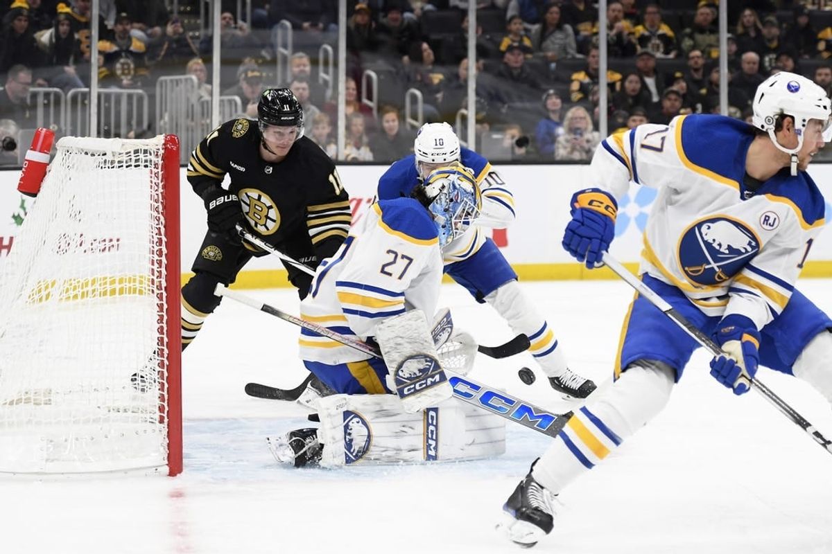 Dec 7, 2023; Boston, Massachusetts, USA; Buffalo Sabres goaltender Devon Levi (27) makes a save in front of Boston Bruins center Trent Frederic (11) and defenseman Henri Jokiharju (10) during the first period at TD Garden.