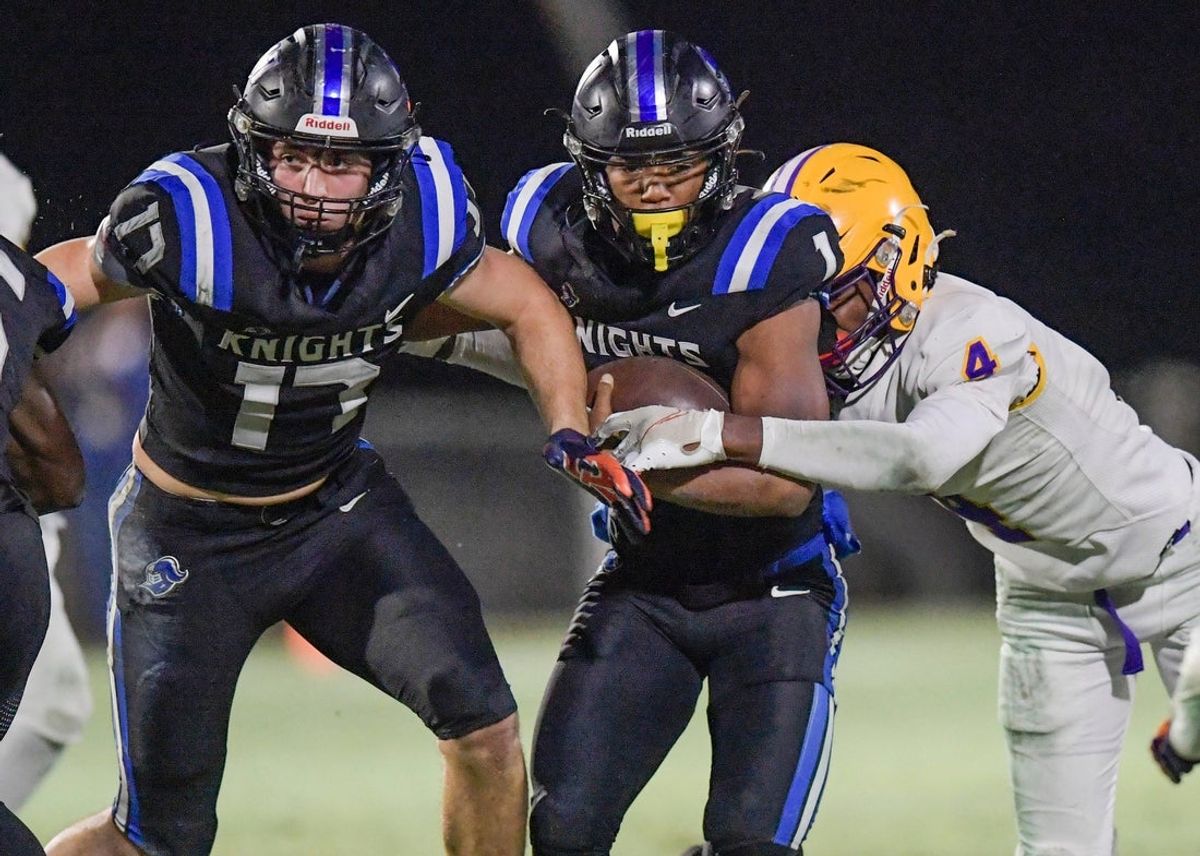 Catholic's Wilson Hodges (17) blocks as Catholic's Caleb McCreary (1) fights for yardage against Booker T. Washington's Marquez Daniel (4) during AHSAA Semi-Final Playoff action on the Catholic campus in Montgomery, Ala., on Friday December 1, 2023.