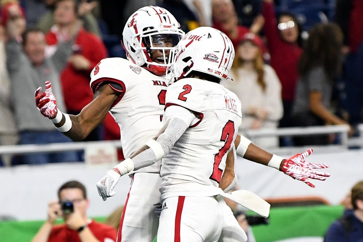 Dec 2, 2023; Detroit, MI, USA;  Miami (OH) Redhawks defensive back Yahsyn McKee (2) celebrates with defensive back William Hardrick (3) after making an interception against the Toledo Rockets in the fourth quarter at Ford Field. Mandatory Credit: Lon Horwedel-Imagn Images