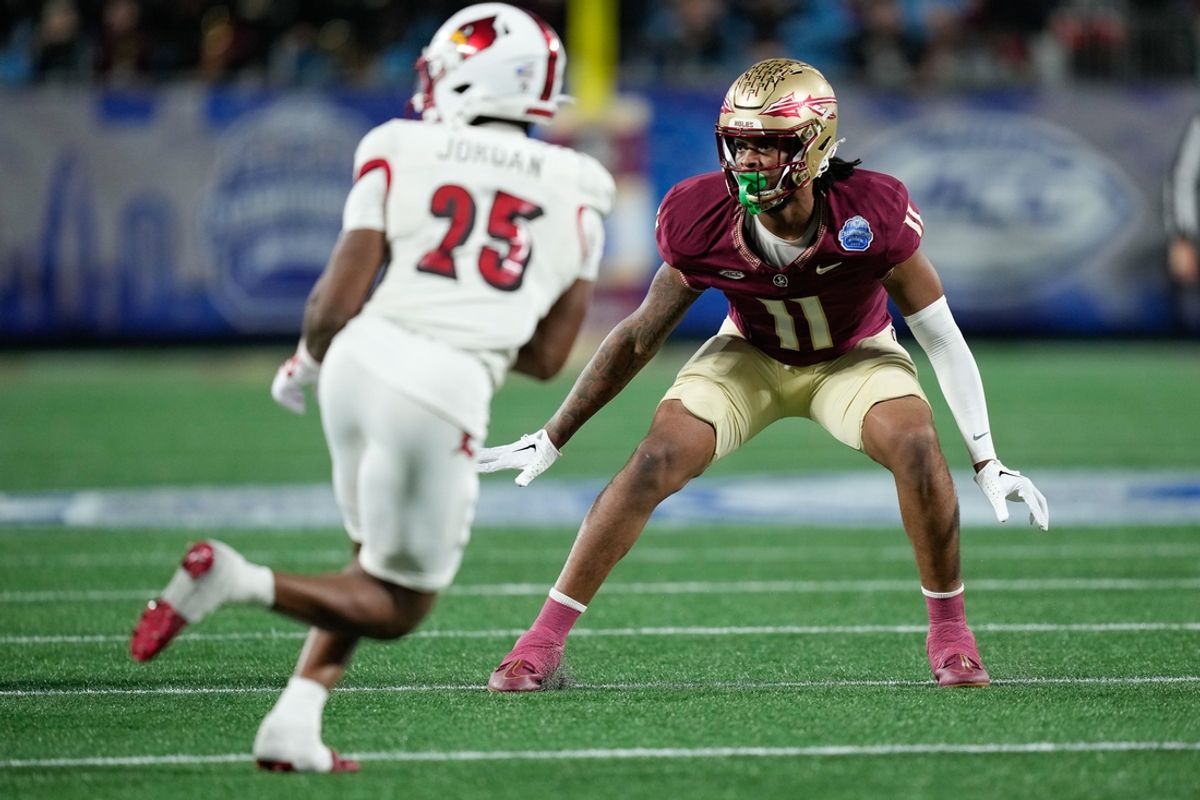 Dec 2, 2023; Charlotte, NC, USA; Florida State Seminoles defensive lineman Patrick Payton (11) defends Louisville Cardinals running back Jawhar Jordan (25) during the third quarter at Bank of America Stadium. Mandatory Credit: Jim Dedmon-Imagn Images
