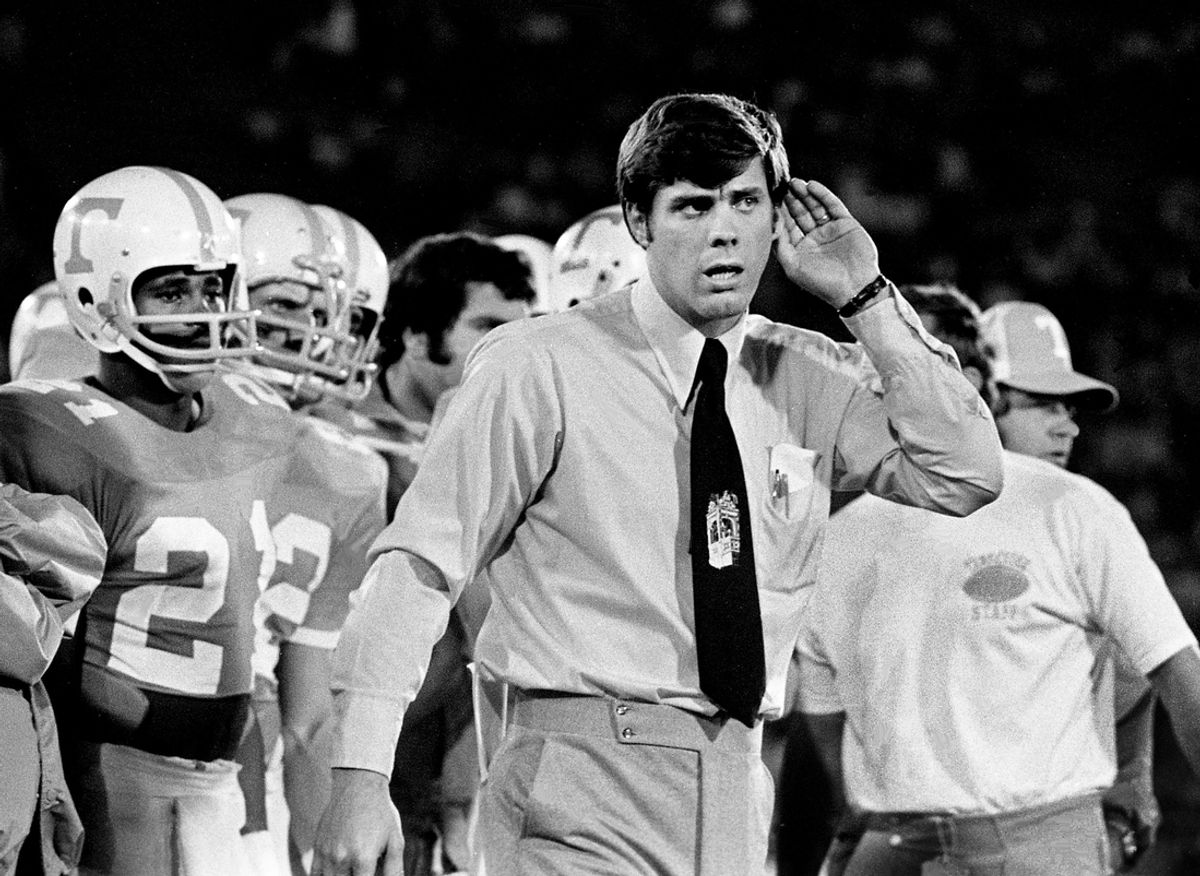 Tennessee head coach Bill Battle, center, is asking an official what going on as his team battles against Texas Tech in the Gator Bowl in Jacksonville, Fla., on Dec. 29, 1973. The Vols comeback bid fell short as Texas Tech won 28-19 before 62,109. Standout freshman Stanley Morgan (21), left, looks on.
