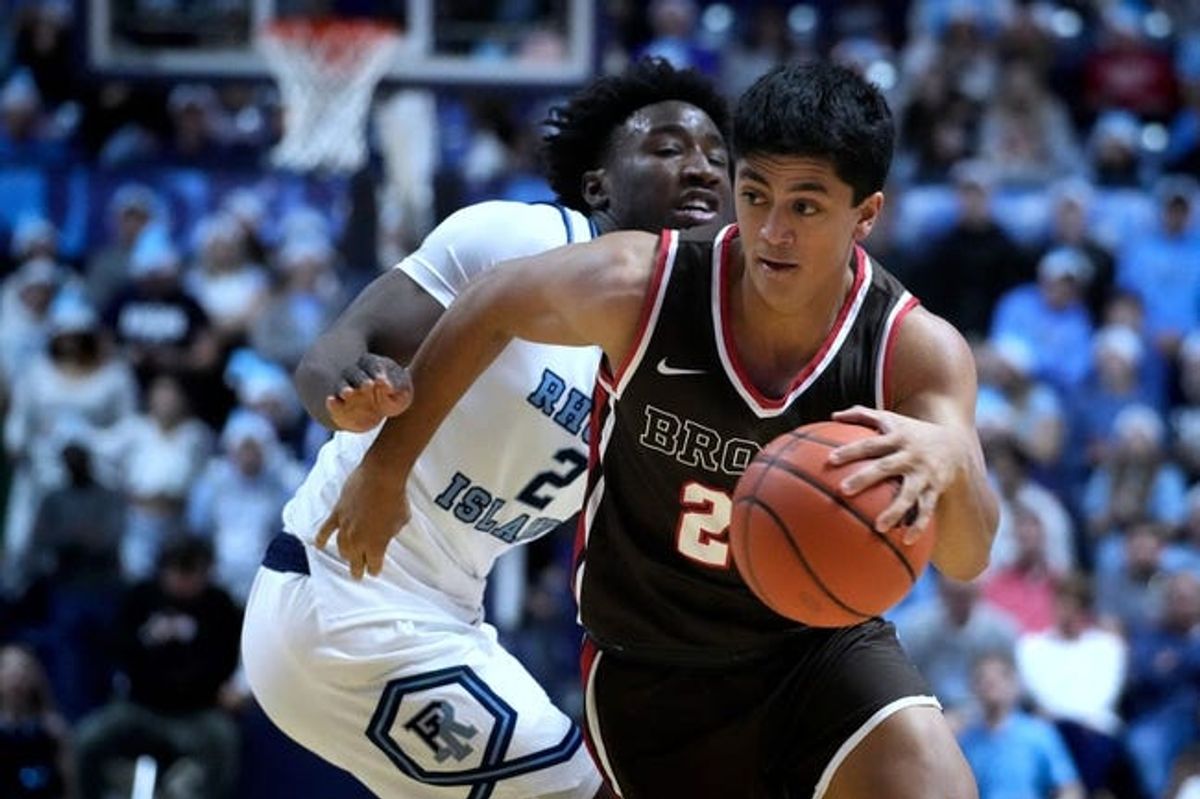 Brown guard Kimo Ferrari gets a step on URI Ram Jaden House and heads to the hoop.