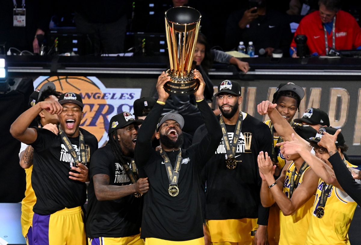 Dec 9, 2023; Las Vegas, Nevada, USA; Los Angeles Lakers forward LeBron James (23) hoists the NBA Cup and celebrates with teammates after winning the NBA In-Season Tournament Championship game against the Indiana Pacers at T-Mobile Arena. Mandatory Credit: Candice Ward-USA TODAY Sports