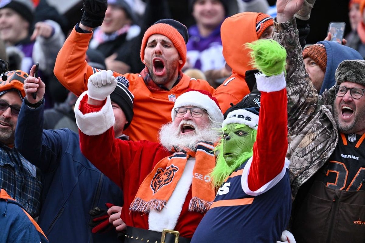 Dec 10, 2023; Chicago, Illinois, USA;  Santa Claus, the Grinch and other fans cheer for the Chicago Bears in the second half during a game against the Detroit Lions at Soldier Field. Mandatory Credit: Jamie Sabau-USA TODAY Sports