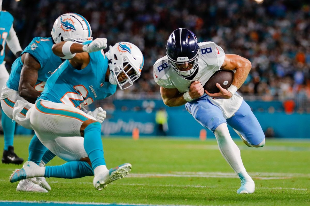 Dec 11, 2023; Miami Gardens, Florida, USA; Tennessee Titans quarterback Will Levis (8) runs with the football as Miami Dolphins safety Brandon Jones (29) prepares to make a tackle during the second quarter at Hard Rock Stadium. Mandatory Credit: Sam Navarro-Imagn Images