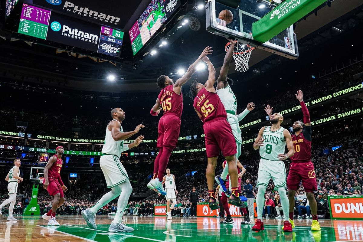 Boston Celtics guard Jaylen Brown (7) shoots against Cleveland Cavaliers guard Donovan Mitchell (45) and forward Isaac Okoro (35) in the second half at TD Garden. Mandatory Credit: David Butler II-Imagn Images