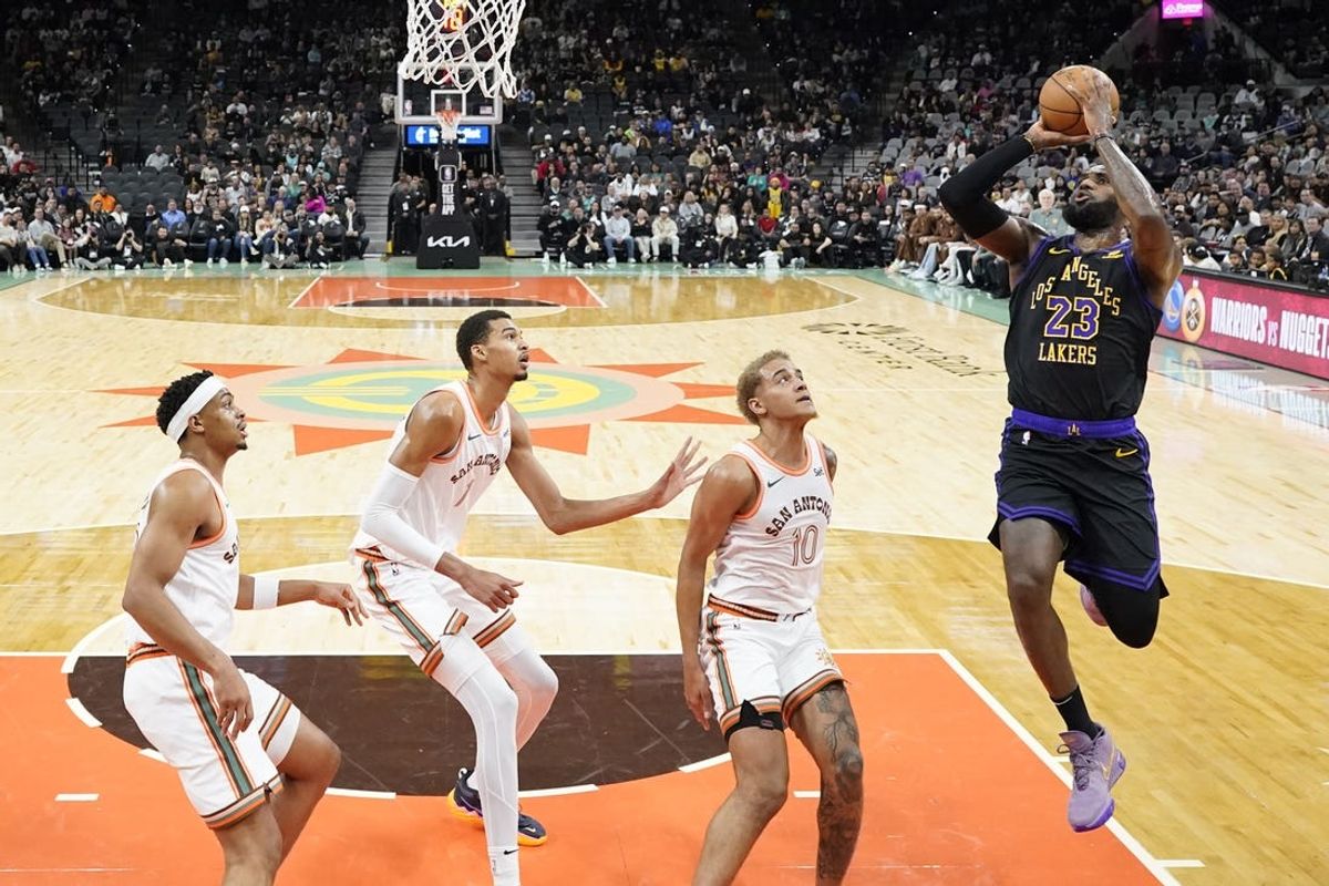 Dec 15, 2023; San Antonio, Texas, USA; Los Angeles Lakers guard LeBron James (23) shoots over San Antonio Spurs forwards Keldon Johnson (3), Victor Wembanyama (1) and forward Jeremy Sochan (10) during the first half at Frost Bank Center. Mandatory Credit: Scott Wachter-USA TODAY Sports