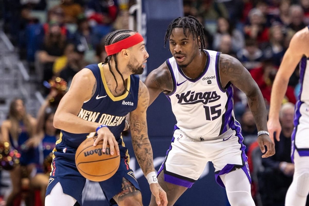 Nov 22, 2023; New Orleans, Louisiana, USA; New Orleans Pelicans guard Jose Alvarado (15) dribbles against Sacramento Kings guard Davion Mitchell (15) during the first half at the Smoothie King Center.