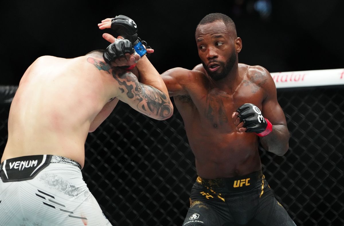 Dec 16, 2023; Las Vegas, Nevada, USA; Leon Edwards (red gloves) fights Colby Covington (blue gloves) during UFC 296 at T-Mobile Arena. Mandatory Credit: Stephen R. Sylvanie-Imagn Images