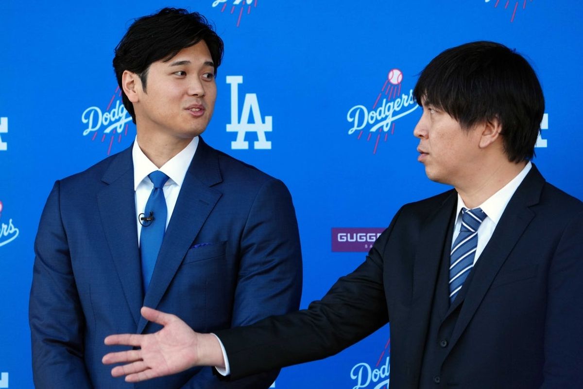 Dec 14, 2023; Los Angeles, CA, USA; Los Angeles Dodgers designated hitter Shohei Ohtan (left) speaks to interpreter Ippei Mizuhara at introductory press conference at Dodger Stadium. Mandatory Credit: Kirby Lee-Imagn Images