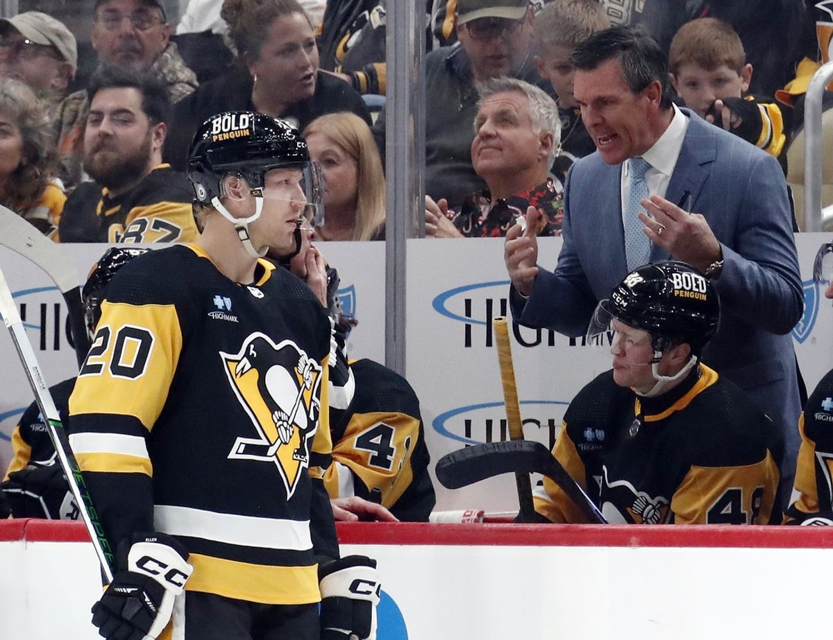 Dec 18, 2023; Pittsburgh, Pennsylvania, USA;  Pittsburgh Penguins head coach Mike Sullivan (right) talks with center Lars Eller (20) at the bench against the Minnesota Wild during the third period at PPG Paints Arena. Pittsburgh won 4-3. Mandatory Credit: Charles LeClaire-Imagn Images