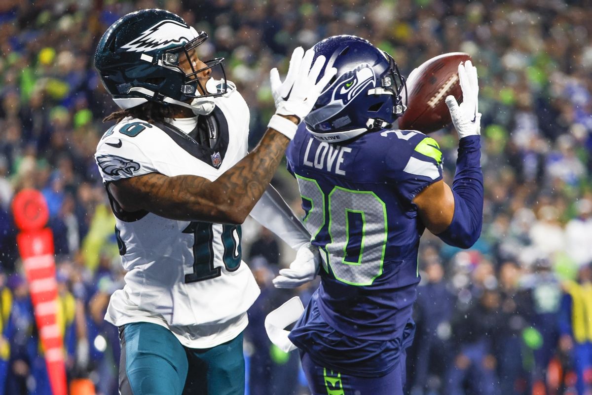 Dec 18, 2023; Seattle, Washington, USA; Seattle Seahawks safety Julian Love (20) intercepts a pass intended for Philadelphia Eagles wide receiver Quez Watkins (16) during the fourth quarter at Lumen Field. Mandatory Credit: Joe Nicholson-USA TODAY Sports