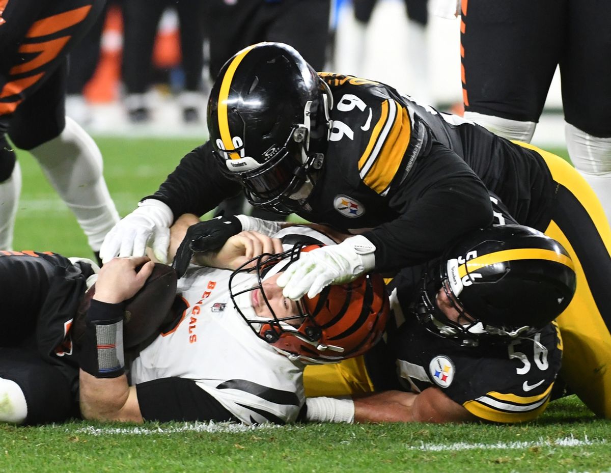 Dec 23, 2023; Pittsburgh, Pennsylvania, USA;  Cincinnati Bengals quarterback Jake Browning (6) is sacked by Pittsburgh Steelers linebacker Alex Highsmith (56) as defensive tackle Larry Ogunjobi (99) takes part on the third quarter play. The Steelers won 34-11. at Acrisure Stadium. Mandatory Credit: Philip G. Pavely-Imagn Images