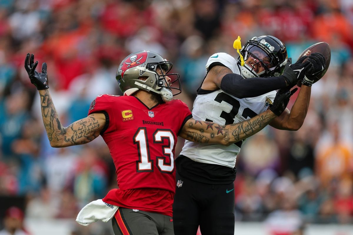Dec 24, 2023; Tampa, Florida, USA;  Jacksonville Jaguars cornerback Tyson Campbell (32) breaks up a pass to Tampa Bay Buccaneers wide receiver Mike Evans (13) in the second quarter at Raymond James Stadium. Mandatory Credit: Nathan Ray Seebeck-USA TODAY Sports