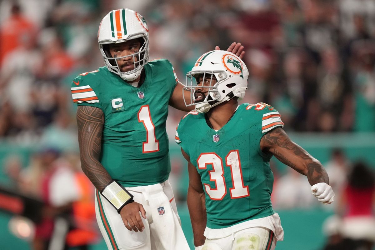 Miami Dolphins quarterback Tua Tagovailoa (1) congratulates running back Raheem Mostert (31) after scoring a touchdown against the Dallas Cowboys during the first half of an NFL game at Hard Rock Stadium in Miami Gardens, Dec. 24, 2023.