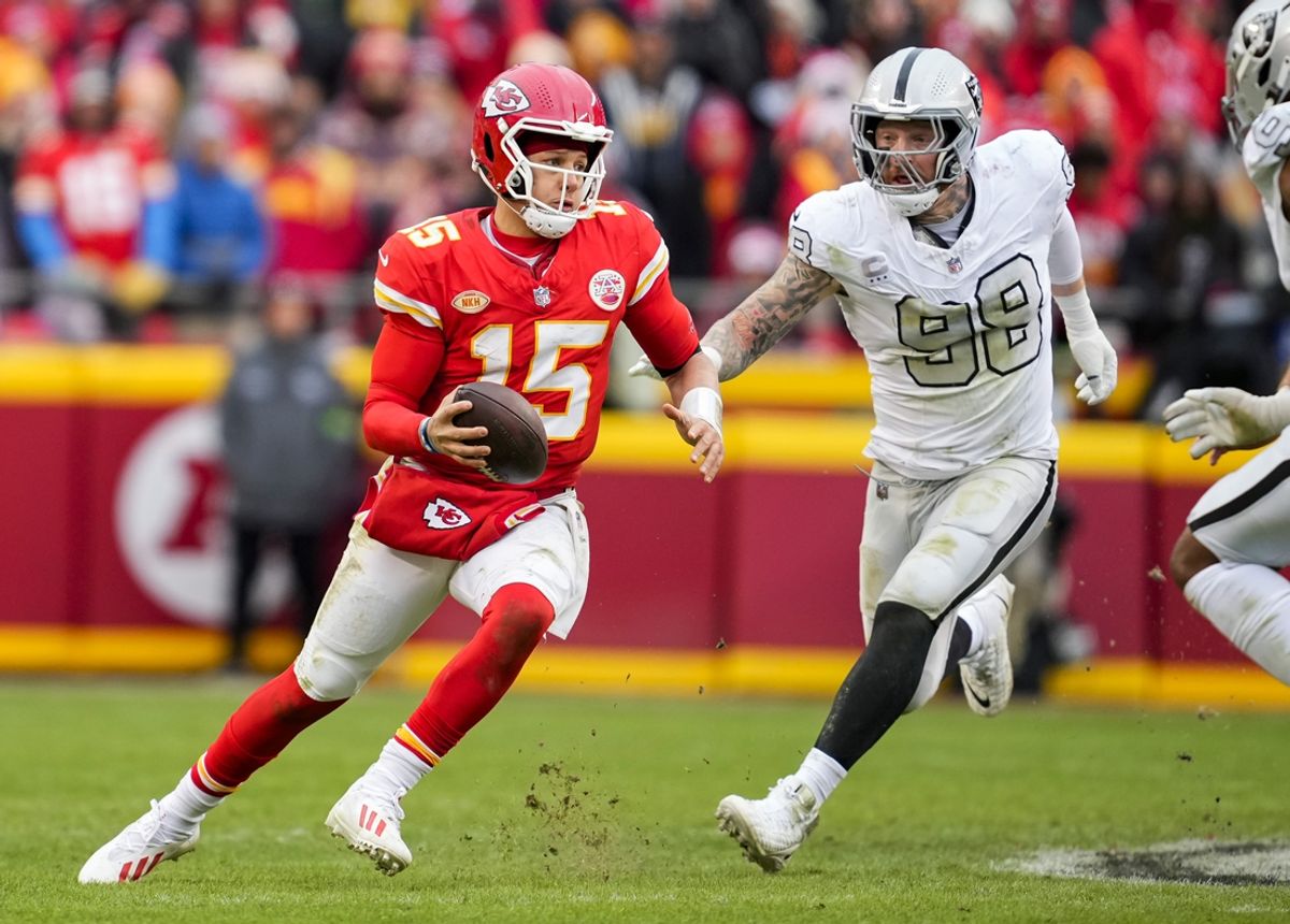 Kansas City Chiefs quarterback Patrick Mahomes (15) scrambles against Las Vegas Raiders defensive end Maxx Crosby (98) during the second half at GEHA Field at Arrowhead Stadium. Mandatory Credit: Jay Biggerstaff-Imagn Images
