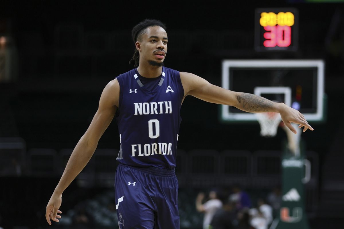 Dec 29, 2023; Coral Gables, Florida, USA; North Florida Ospreys guard Jasai Miles (0) signals against the Miami Hurricanes during the second half at Watsco Center. Mandatory Credit: Sam Navarro-Imagn Images