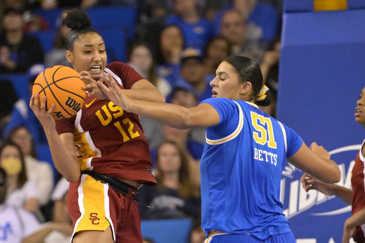Dec 30, 2023; Los Angeles, California, USA; USC Trojans guard JuJu Watkins (12) keeps the ball from UCLA Bruins center Lauren Betts (51) in the second half at Pauley Pavilion presented by Wescom. Mandatory Credit: Jayne Kamin-Oncea-Imagn Images