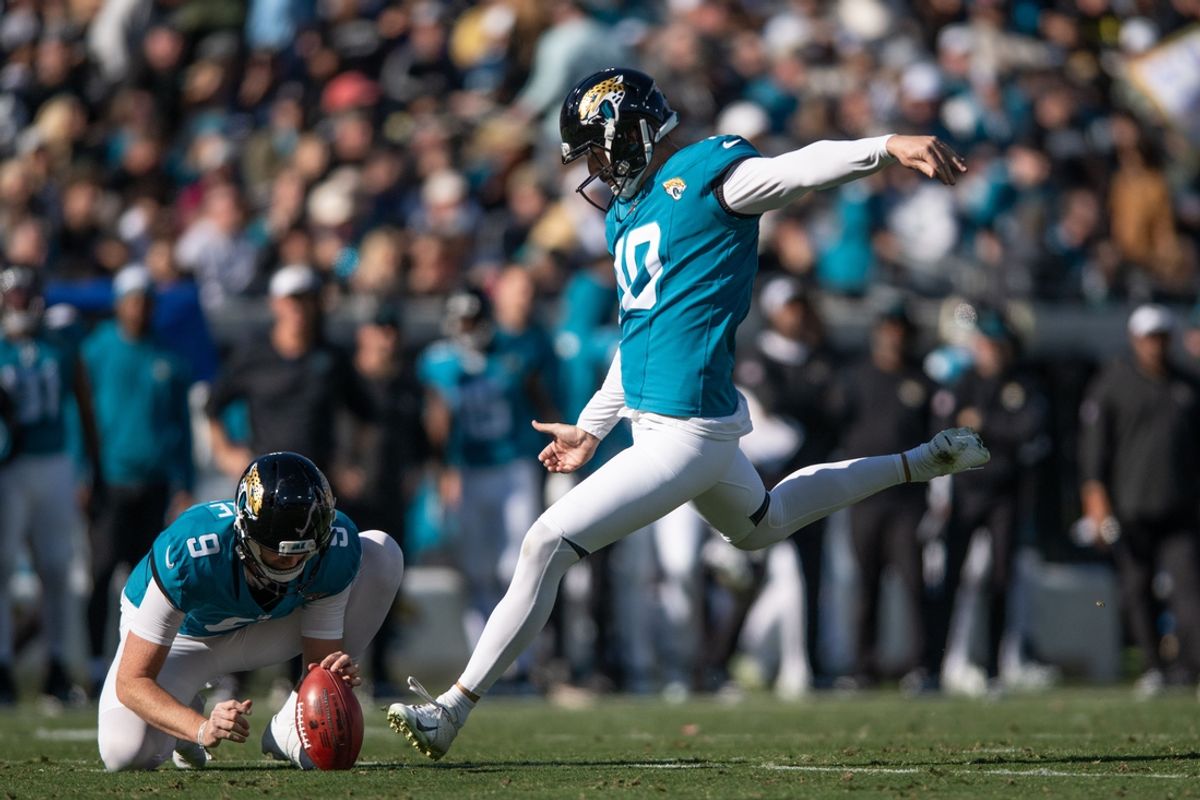 Dec 31, 2023; Jacksonville, Florida, USA; Jacksonville Jaguars punter Logan Cooke (9) holds the ball andnkicker Brandon McManus (10) make the field goal against the Carolina Panthers in the second quarter at EverBank Stadium. Mandatory Credit: Jeremy Reper-Imagn Images