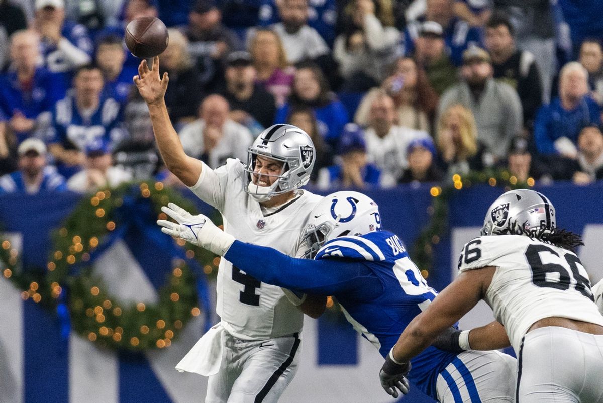 Dec 31, 2023; Indianapolis, Indiana, USA; Las Vegas Raiders quarterback Aidan O'Connell (4) passes the ball while Indianapolis Colts defensive tackle DeForest Buckner (99) defends  in the first half at Lucas Oil Stadium. Mandatory Credit: Trevor Ruszkowski-Imagn Images
